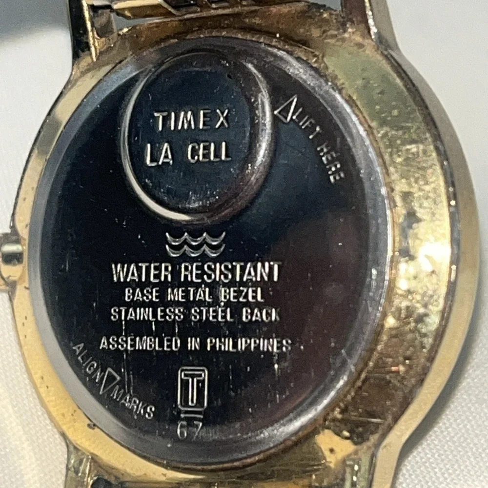 Vintage Gold Band Timex Watch. LA CELL. White Face. Metal Band. Needs Battery‎
